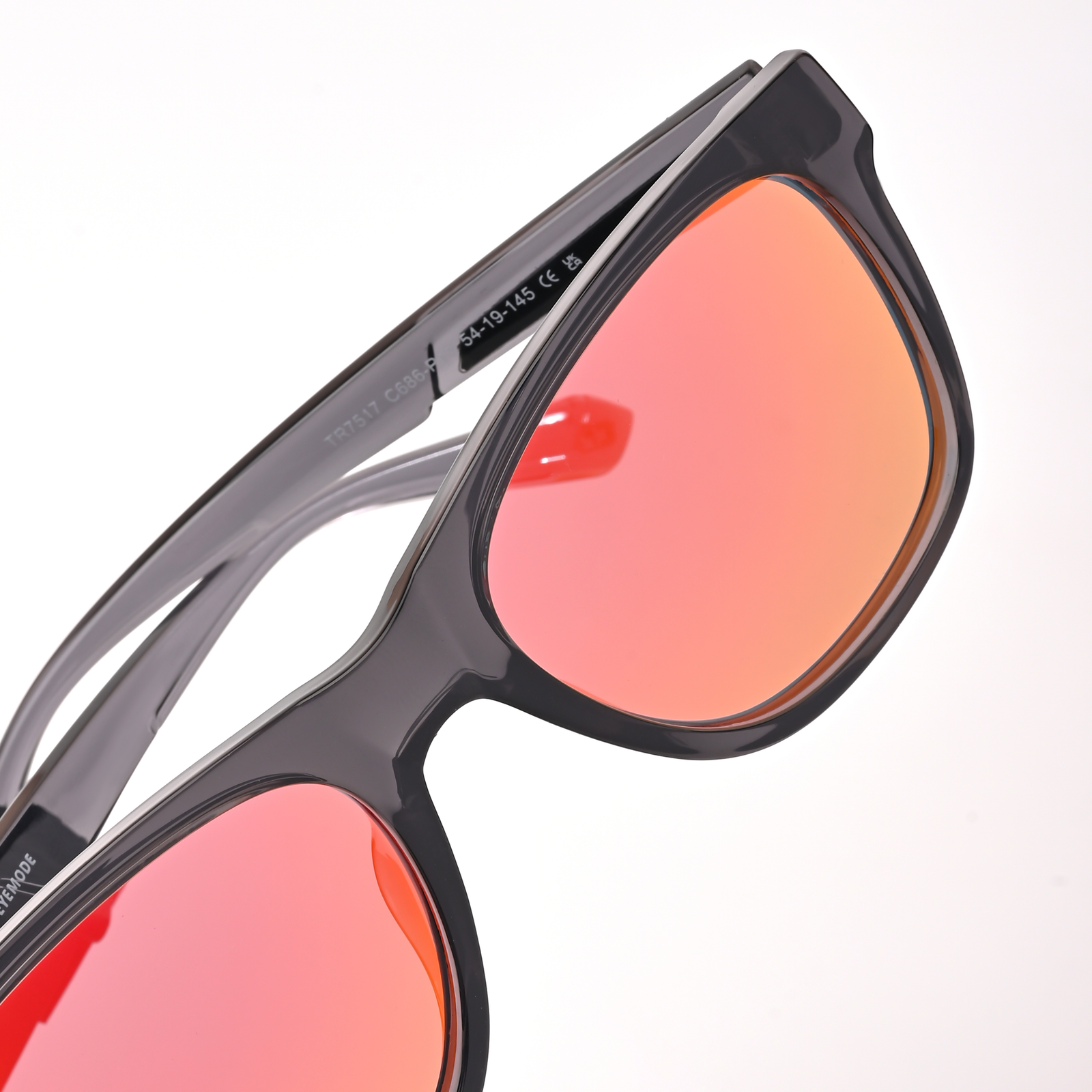 Close-up of sleek black sunglasses with reflective orange lenses, showcasing the modern design of Aventus - Carbon Ice for stylish UV protection.