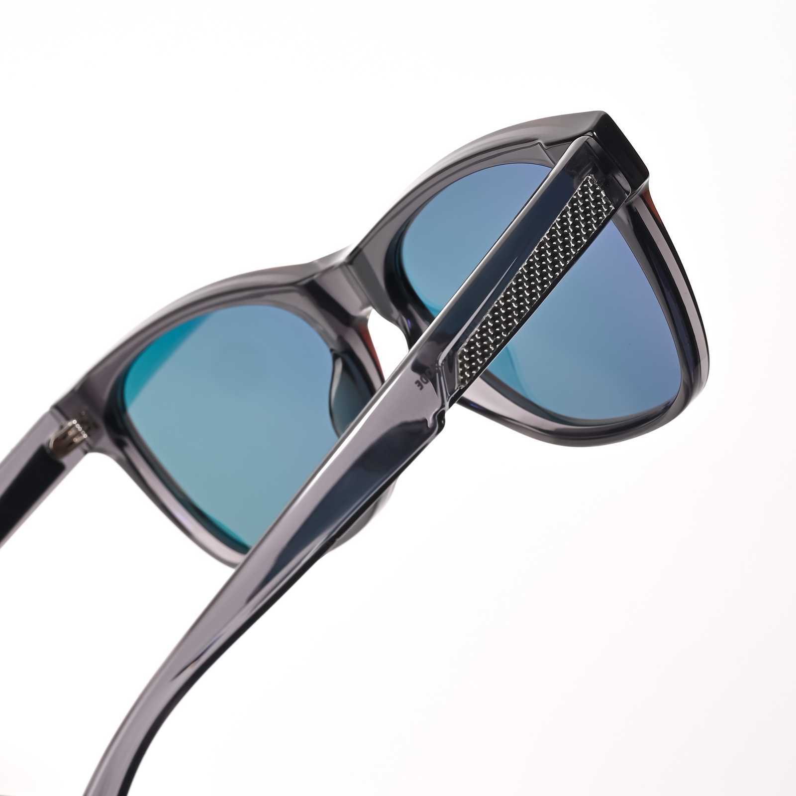 Close-up of stylish Aventus - Carbon Ice sunglasses featuring blue tinted lenses and a sleek black frame with textured detailing on the temples for premium sun protection and a modern look.